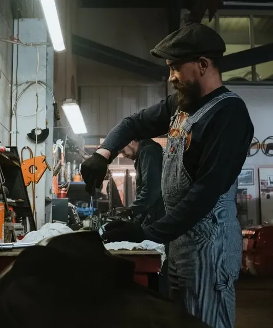 A mechanic working on a car in a garage