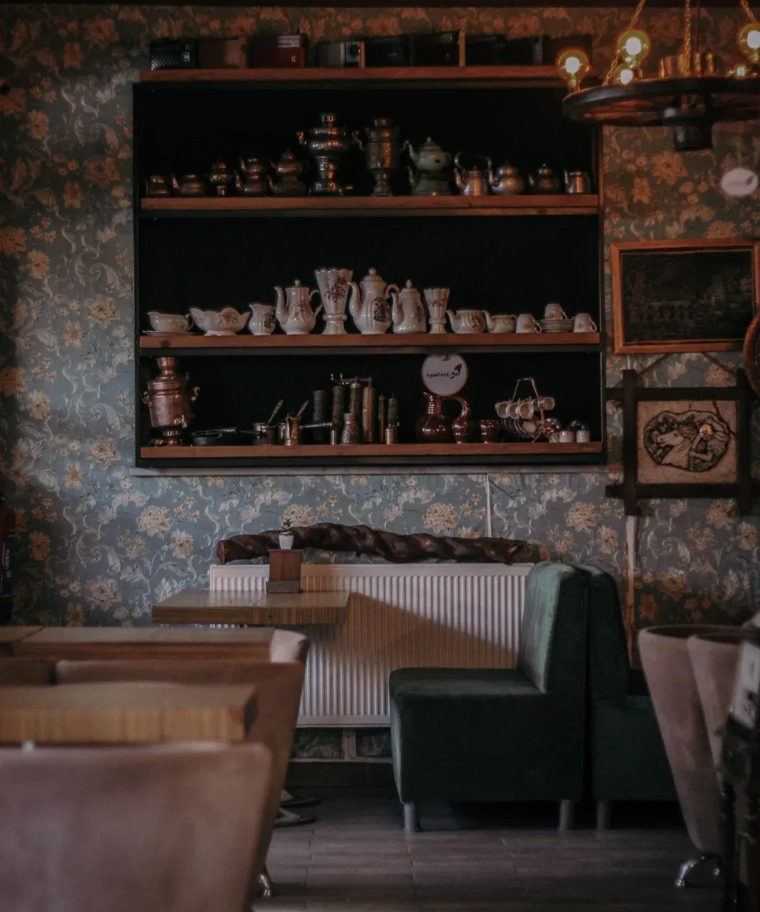 A warmly lit bar with stools lined up along the counter