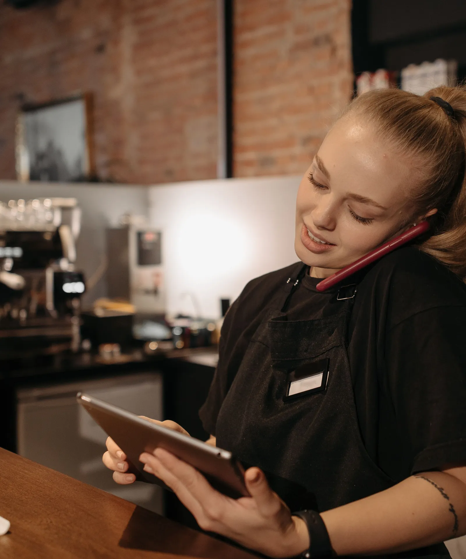 A barista pouring latte art into a cup