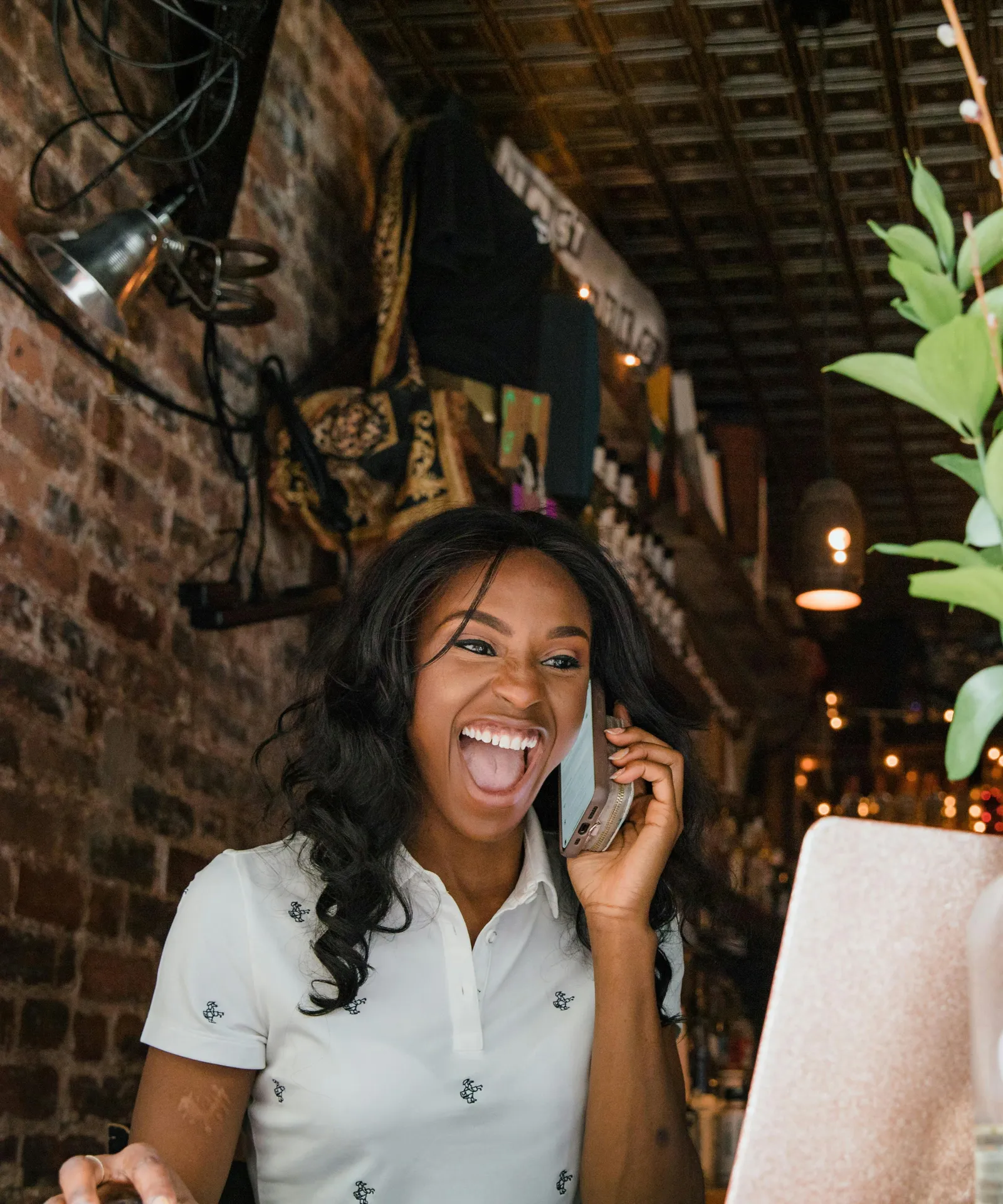 A woman on a phone call while working at her laptop